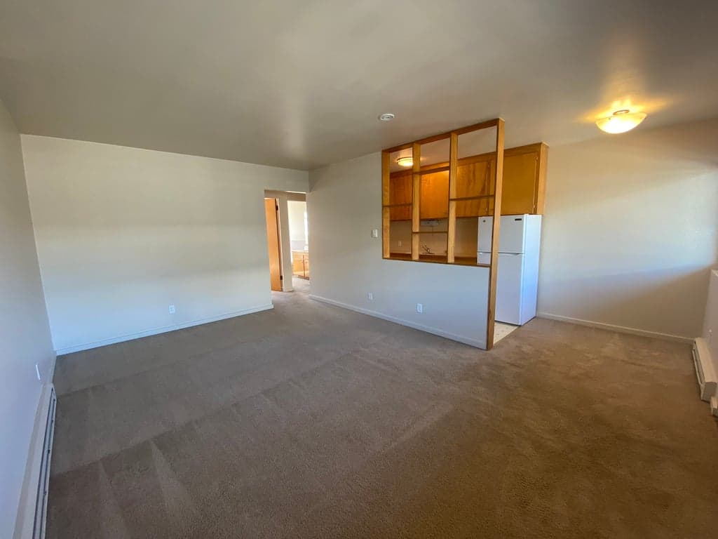 Bright living room in a Cortina Apartments rental unit, Seattle, showcasing modern finishes and large windows